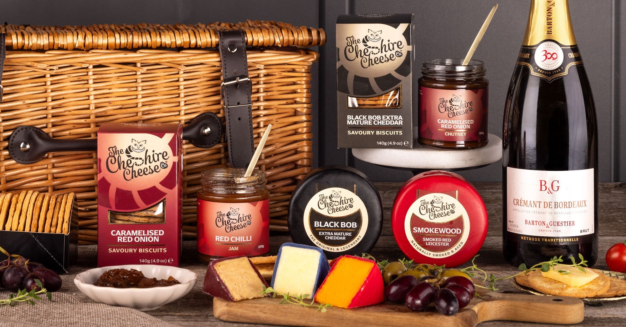 Curated cheese hamper with waxed truckles, chutney, biscuits and sparkling wine