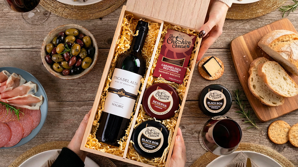 Cheese and wine hamper with waxed cheese truckles and a bottle of wine